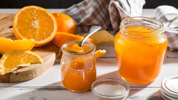 High angle of transparent jar with orange jam