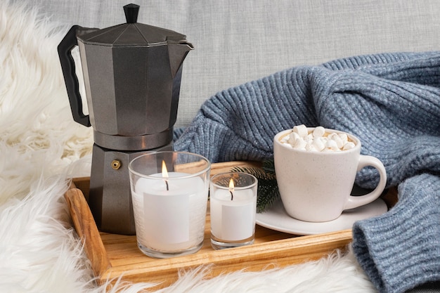 High angle of tray with candles and kettle