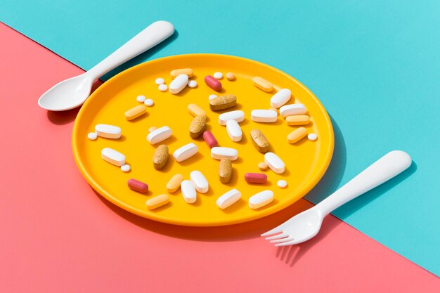High angle of tray with pills and cutlery