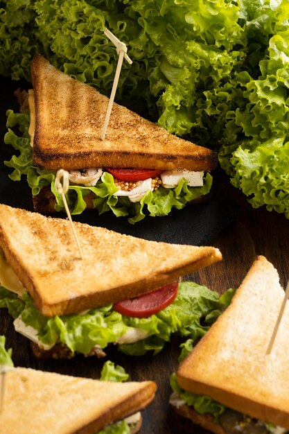 high angle of triangle salad and tomatoes sandwiches