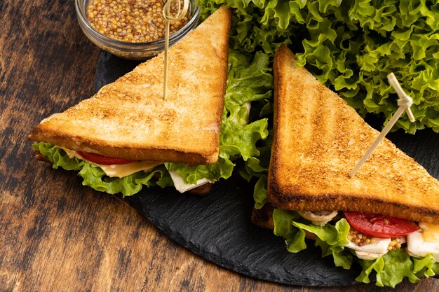 high angle of triangle sandwiches on slate with salad