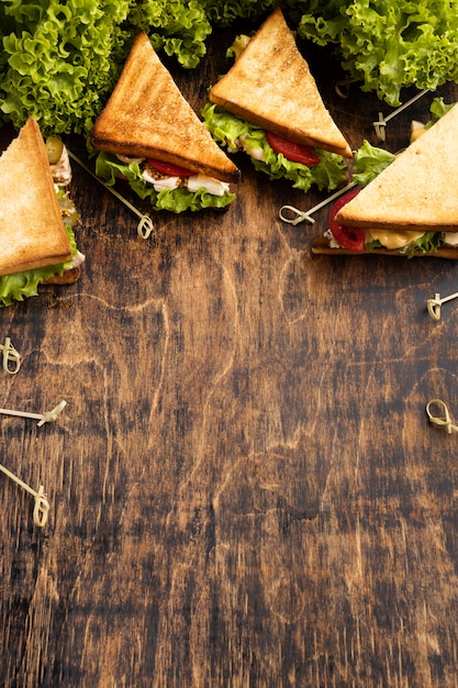 High angle of triangle sandwiches with tomatoes and salad