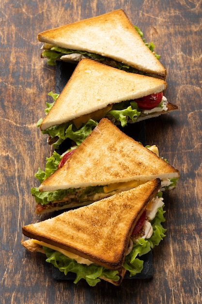 High angle of triangle sandwiches with tomatoes