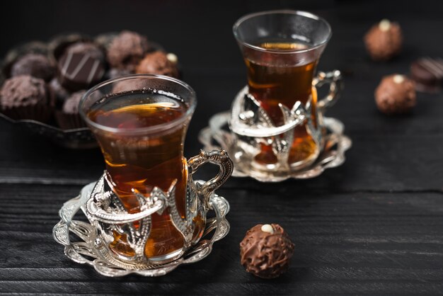 High angle of truffles and cups of tea