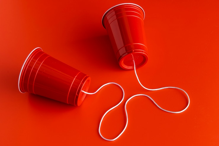Free Photo high angle of two paper cups with string
