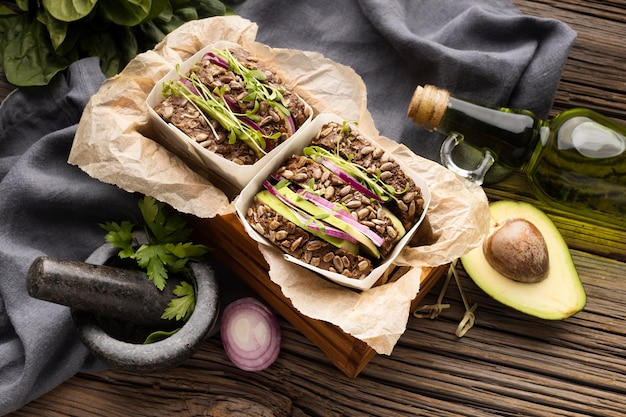 High angle of two sandwiches with salad and avocado