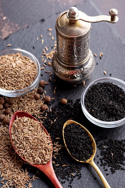 High angle of variety of spices with grinder