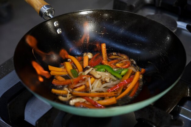 High angle of vegetables getting sauteed in the pan