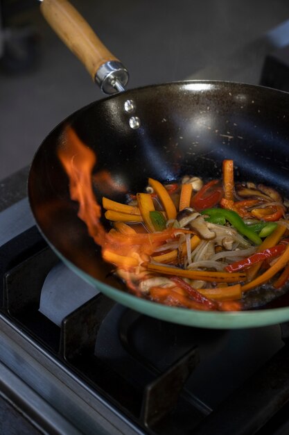 High angle of vegetables getting sauteed in the pan