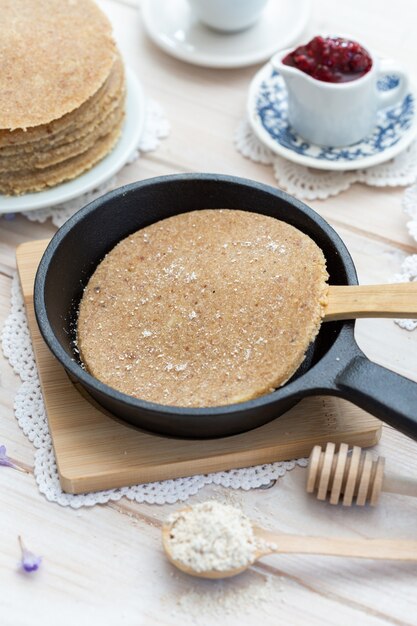 High angle vertical closeup shot of raw vegan pancakes in an aesthetic table design