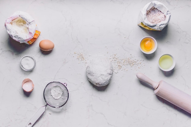 High angle view of baking ingredients and utensils on white background