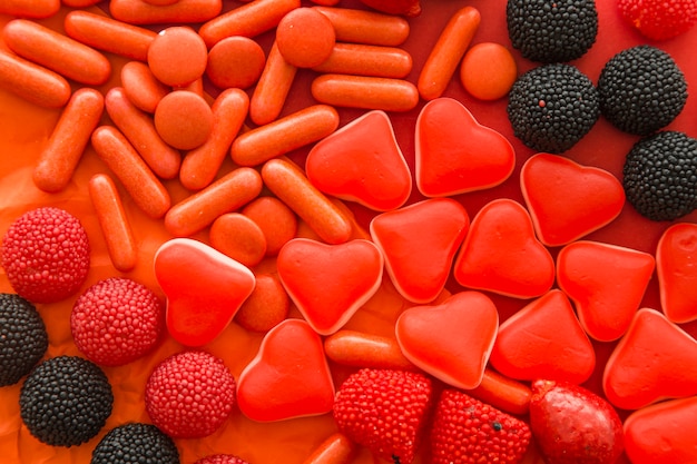 High angle view of berry fruits, heart shape and capsule candies