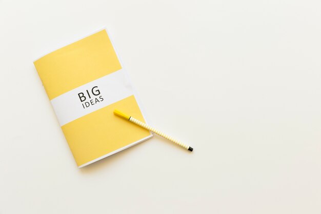 High angle view of big ideas diary with pen on white background