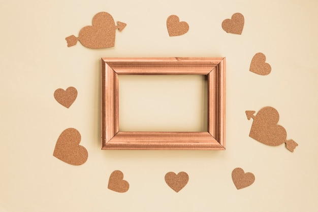 Free photo high angle view of blank frame surrounded with beige background