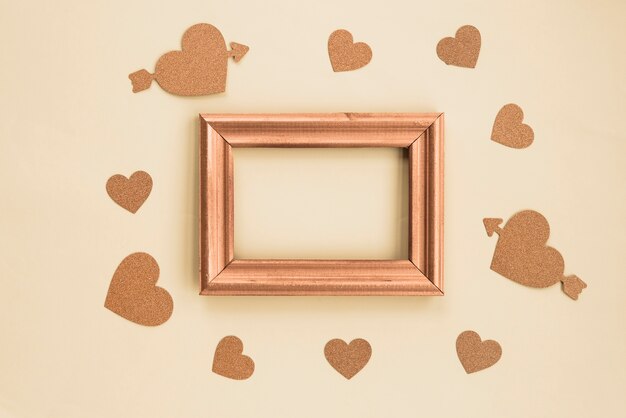 High angle view of blank frame surrounded with beige background