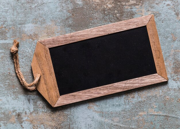 High angle view of blank wooden tag on rusty background