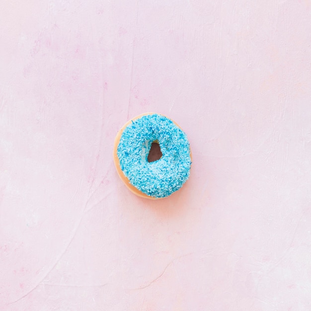 High angle view of blue donut on pink background