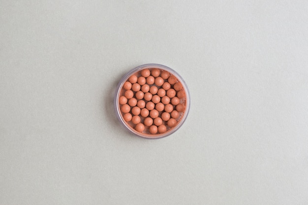 High angle view of bronzing pearls on white background