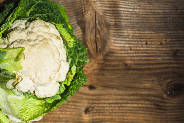 High angle view of cauliflower on wooden background