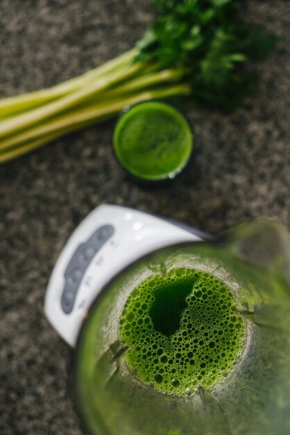 High angle view of celery smoothie in blender