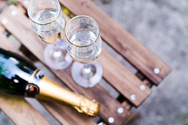 High angle view of champagne glass on wooden table