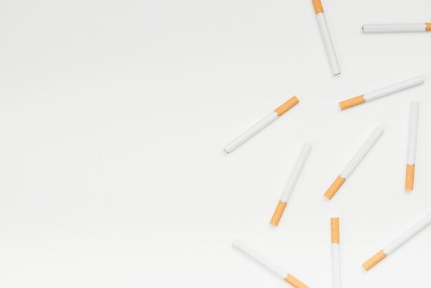 High angle view of cigarettes against white surface