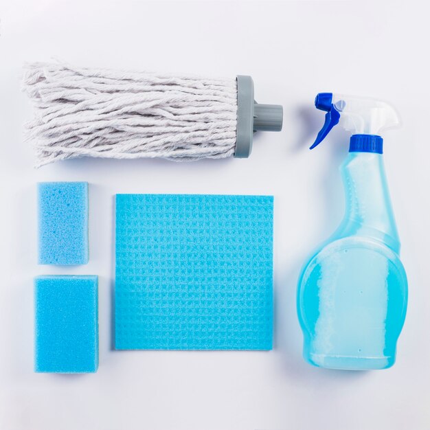 High angle view of cleaning equipments on grey background