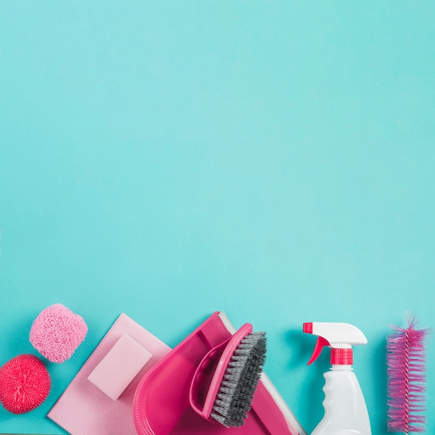 High angle view of cleaning equipments on turquoise background