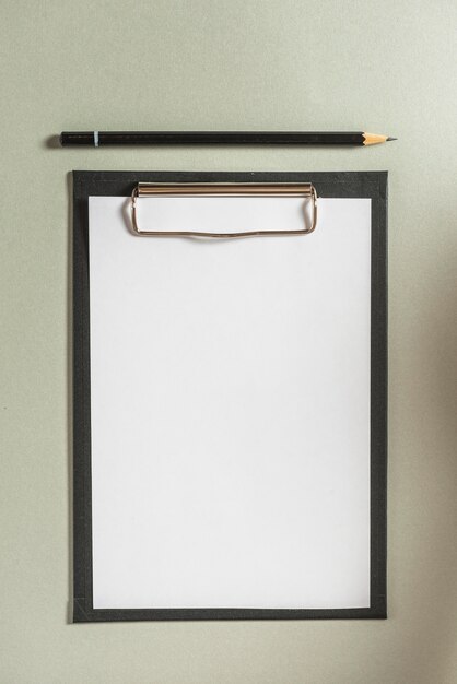 High angle view of clipboard with blank white paper and pencil