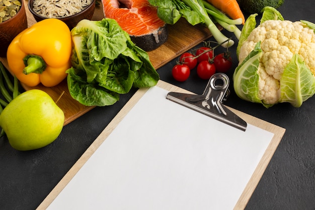 High angle view clipboard with vegetables