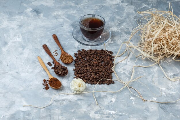 High angle view coffee beans, cup of coffee with coffee beans, instant coffee