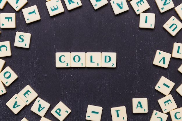 High angle view of cold text on scrabble letters