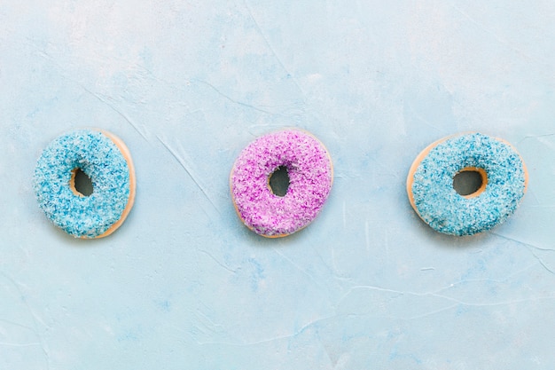 High angle view of colorful donuts on blue background