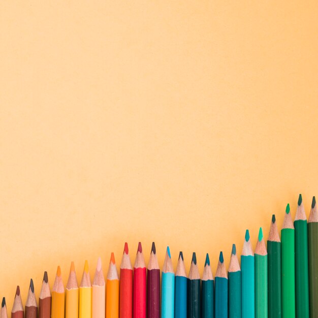High angle view of colorful pencils over the colored background