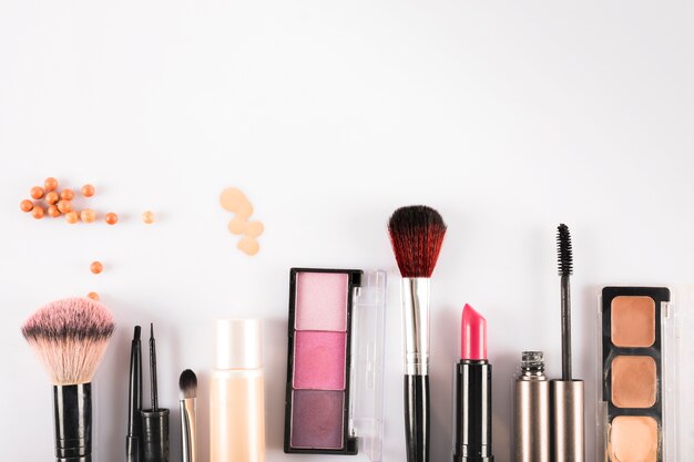 High angle view of cosmetic beauty products on white backdrop
