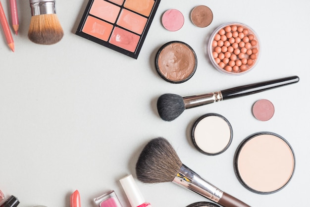 High angle view of cosmetic products on white backdrop