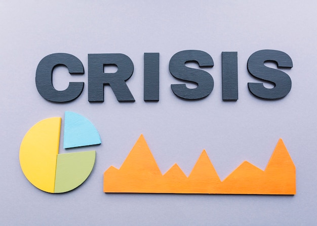 High angle view of crisis word with graphs on grey background