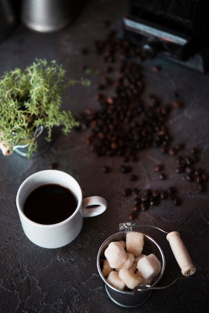 High angle view cup of coffee with sugar cubes