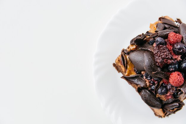 High angle view of delicious pastry on plate over white background