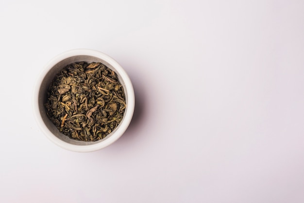 High angle view of dry petals in bowl on white background