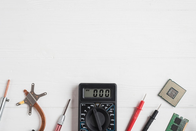 Free photo high angle view of electronic tools with computer chips on wooden background