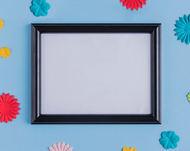 Free photo high angle view of empty white frame with black wooden border