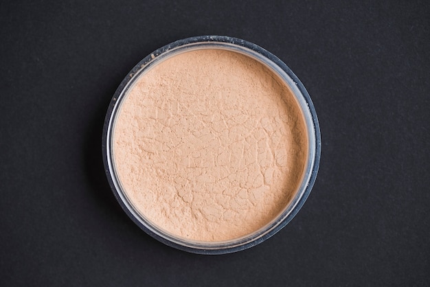 High angle view of face powder on black background