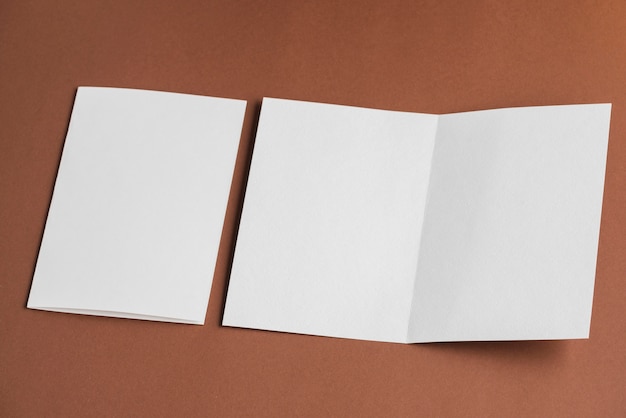 High angle view of folded and unfolded blank white papers