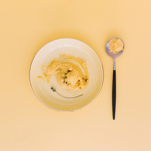 High angle view of fresh chickpea hummus on plate