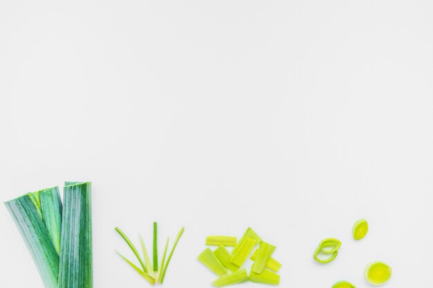 High angle view of fresh chopped leek on white background