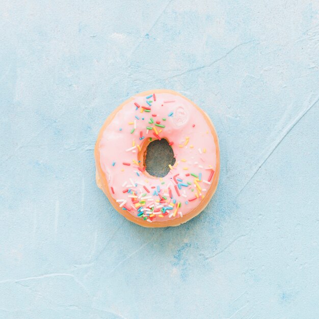 High angle view of fresh donut on blue backdrop