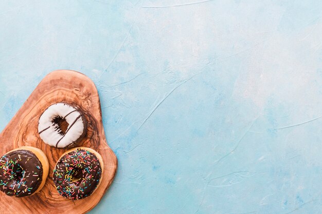 High angle view of fresh donut on wooden chopping board