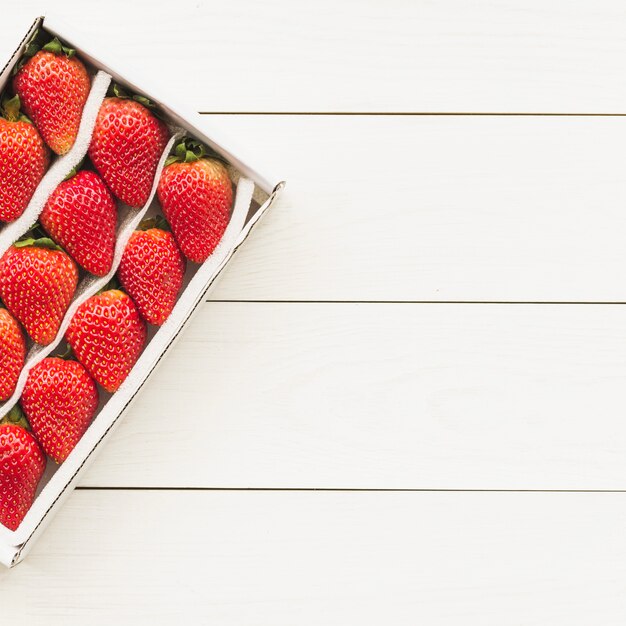 High angle view of fresh strawberries on wooden background