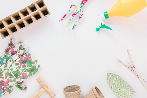 High angle view of gardening tools against white background